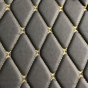 Meterware in schwarz mit goldenen Nähten/Faden