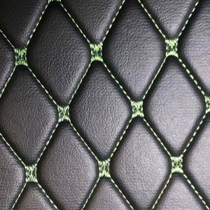 Meterware in schwarz mit grünen Nähten/Faden
